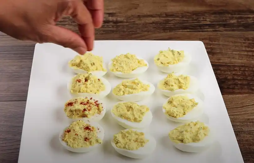 garnishing the deviled eggs